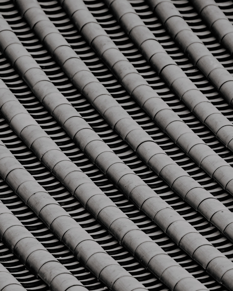 Close-up image of traditional grey Korean roof tiles arranged in uniform patterns.