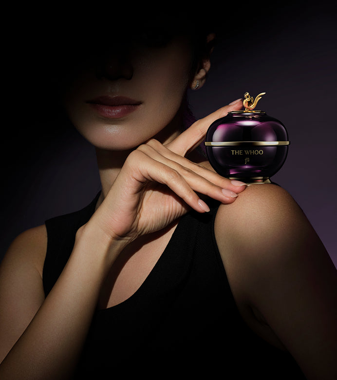 A woman elegantly holding the Imperial Youth Cream, highlighting its sophistication.