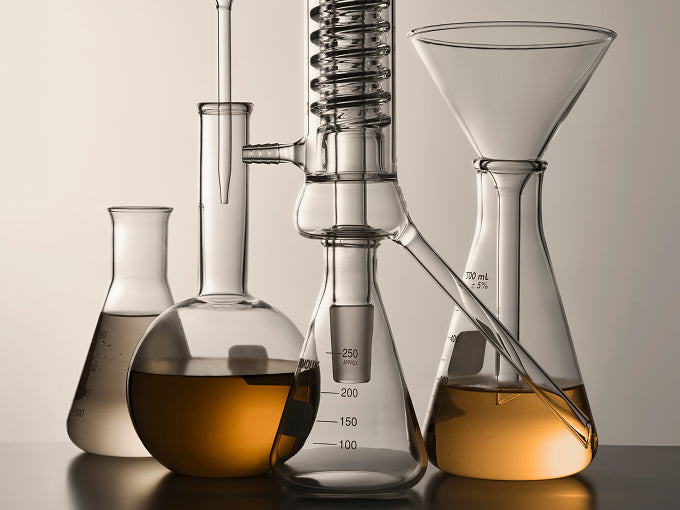 Image of glass laboratory containers filled with essential formula.