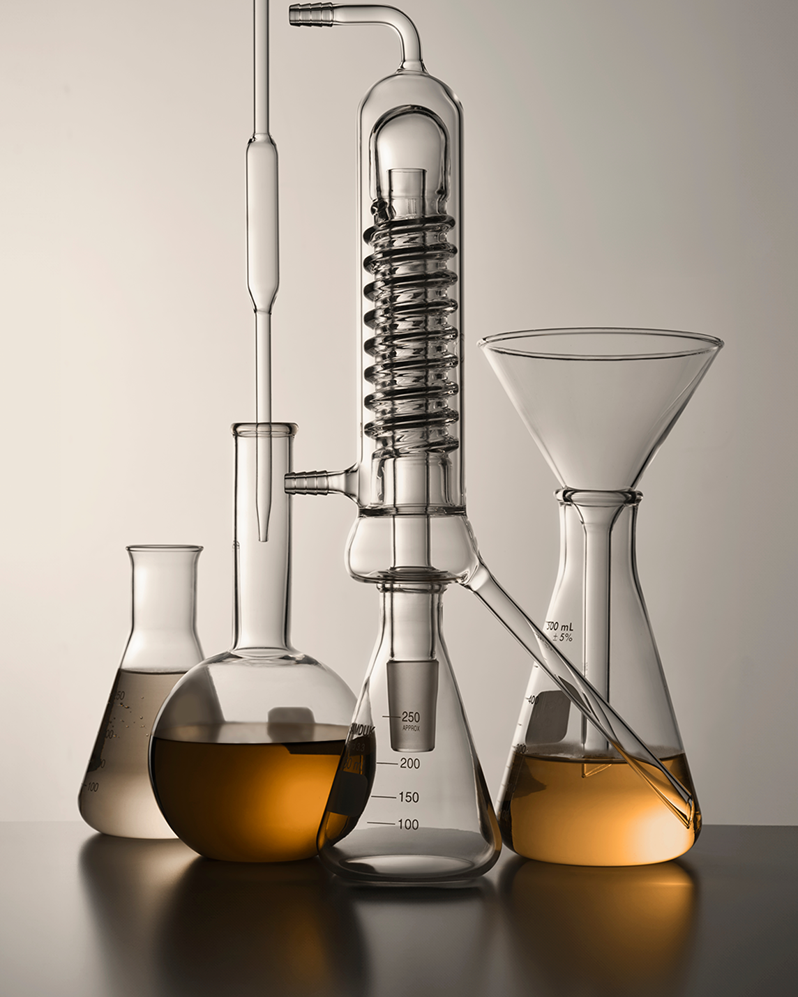 Image of glass laboratory containers filled with essential formula.