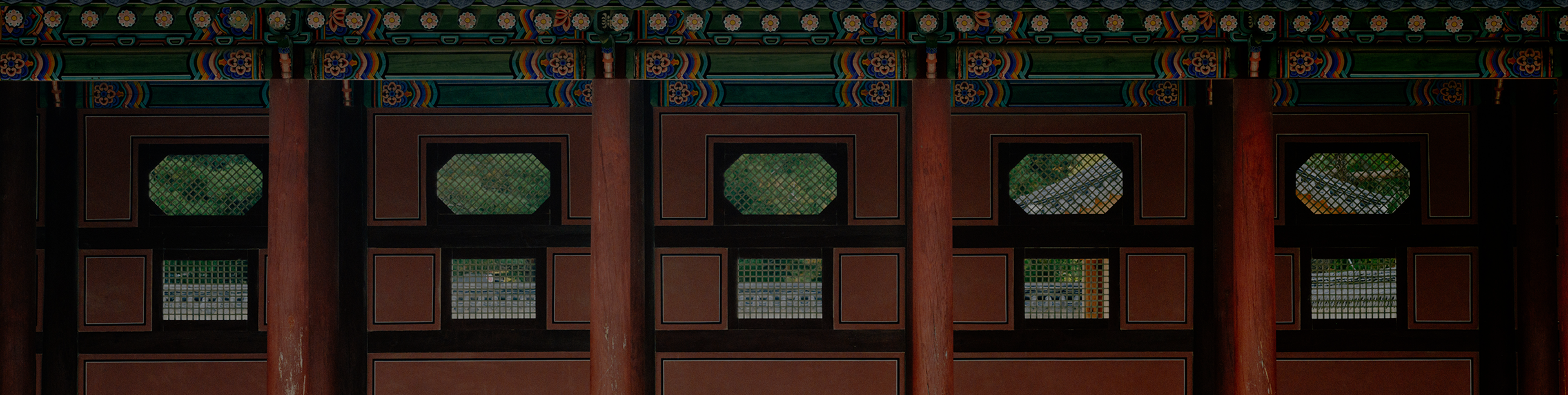 A wide panoramic shot of Gyeongbokgung Palace in Seoul, South Korea. The palace buildings, with their traditional Korean architecture, stretch across the frame under a clear sky. The scene is captured from a slightly elevated angle, offering a comprehensive view of the palace grounds. 